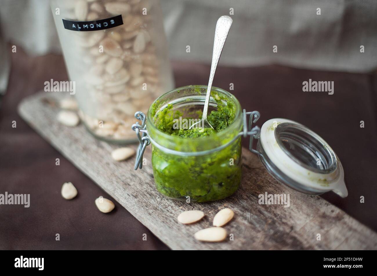Close-up of homemade, vegan and gluten-free pesto sauce in glass jar. Stock Photo