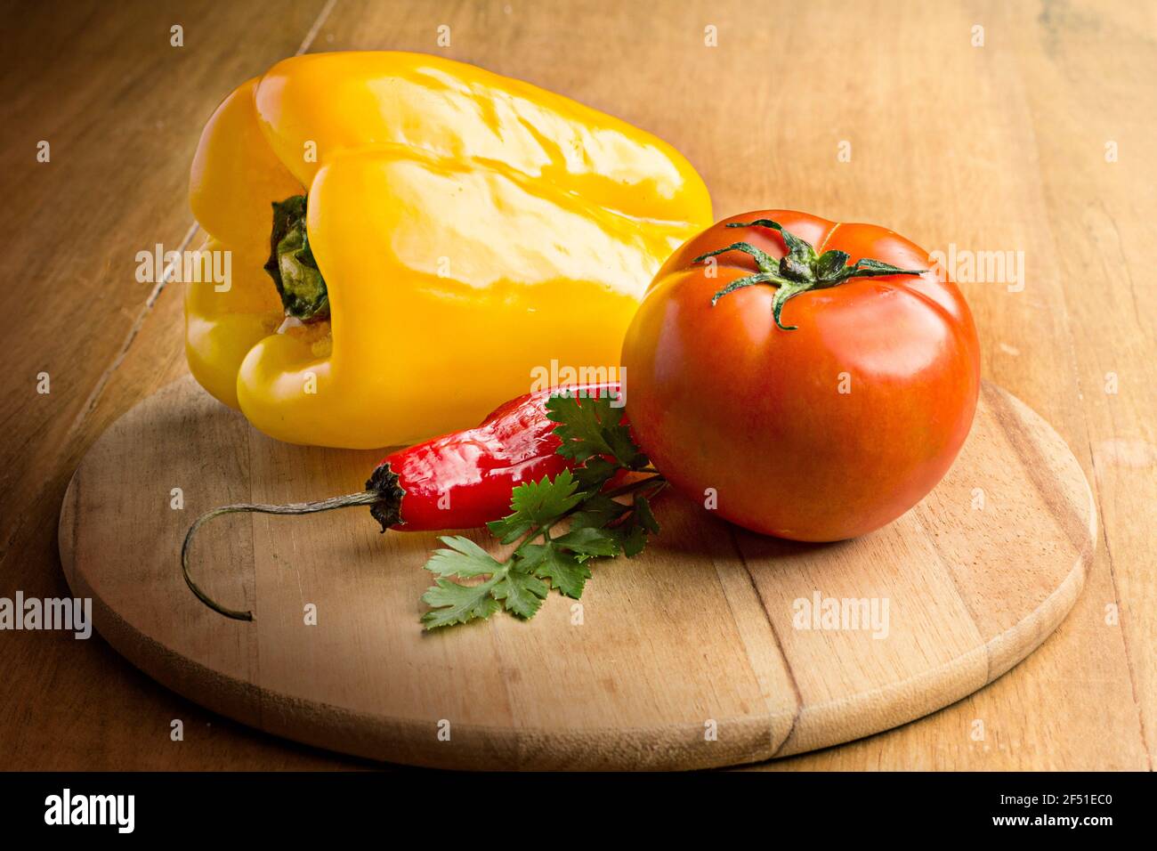 tomato yellow and red pepper on the wood table Stock Photo