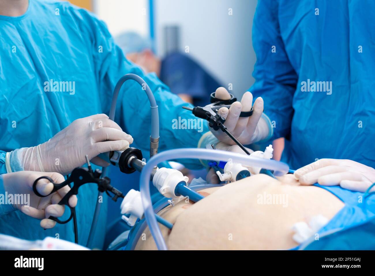 A surgeon in latex gloves and a blue uniform holds special medical
