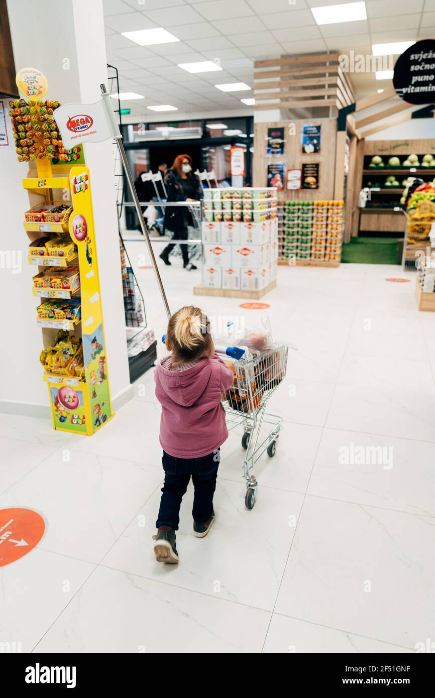 Budva, Montenegro - 17 march 2021: A child with a small trolley in the  supermarket, go shopping with his mother. The family goes shopping Stock  Photo - Alamy