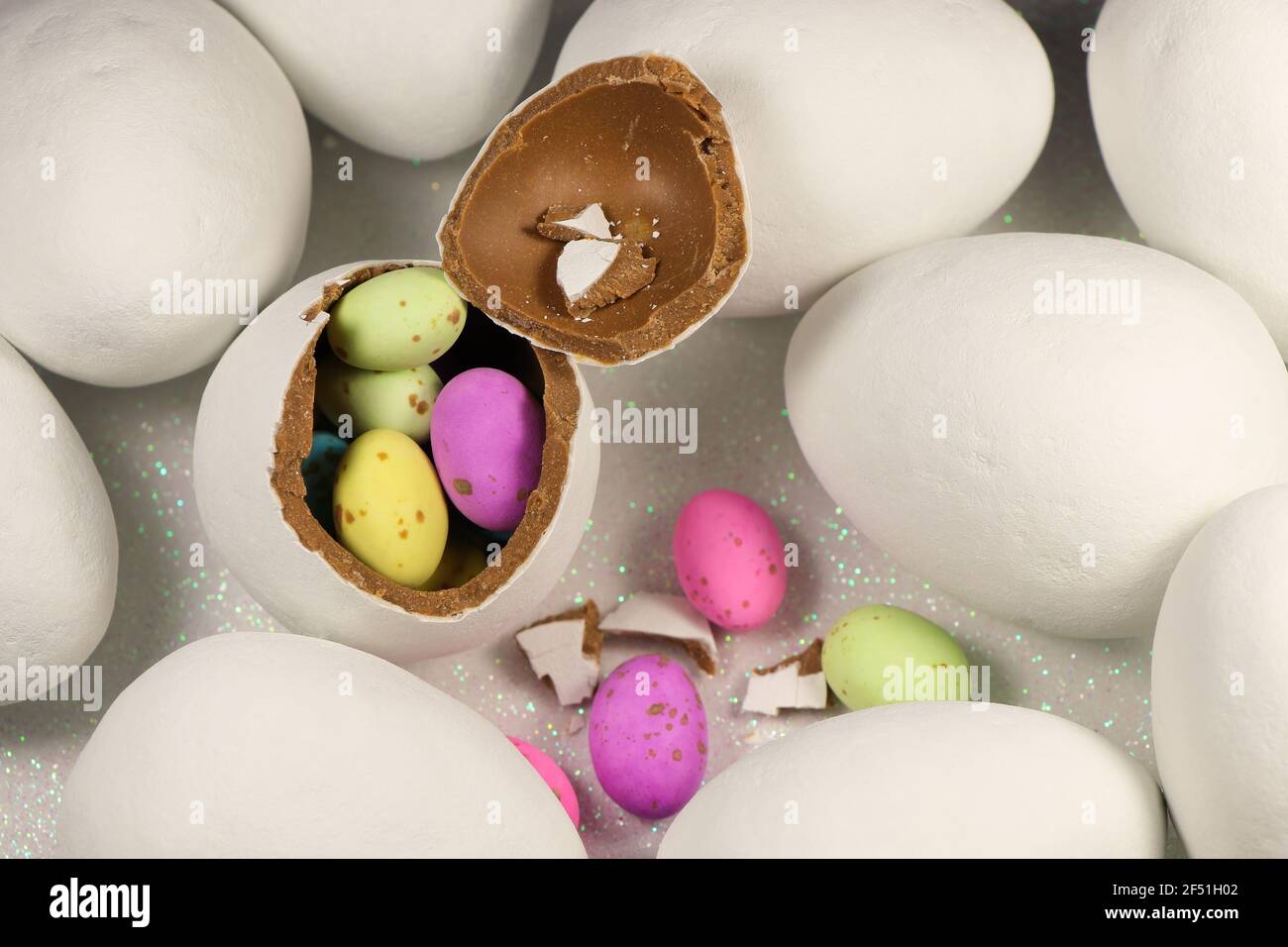 Chocolate Egg Filled With Colorful Speckled Candy Eggs Stock Photo