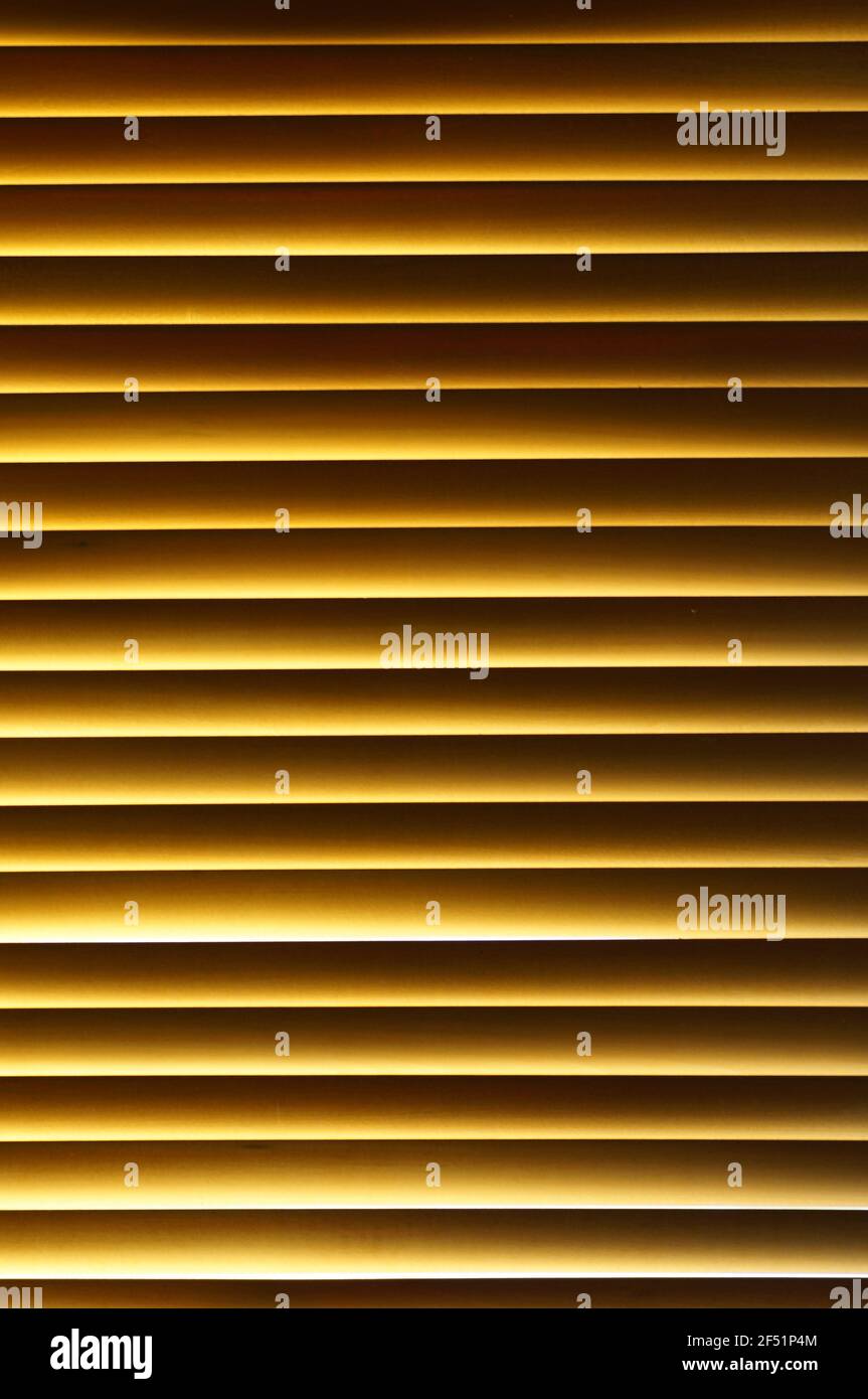 Wood blinds in the window. Natural wood window curtains. Pattern with horizontal wooden lines. Blinds in enlargement. Stock Photo