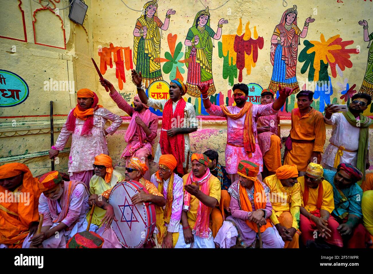 Mathura, India. 23rd Mar, 2021. Devotees singing songs celebrating during the Lathmar Holi Festival of Barsana.The myth behind this festival is related to Hindu God Lord Krishna who as per local belief came from his hometown Nandgaon to Barsana to tease Radha (a Hindu goddess and a consort of the god Krishna) and her friends. For more than 100 years, women of Barsana still maintaining the ritual. (Photo by Avishek Das/SOPA Images/Sipa USA) Credit: Sipa USA/Alamy Live News Stock Photo