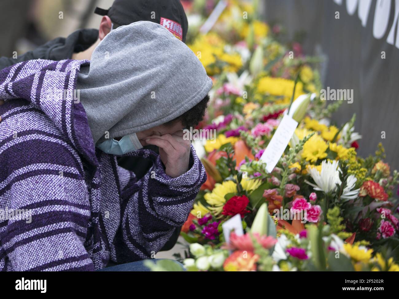 Boulder, United States. 23rd Mar, 2021. A man grieves after laying flowers outside a King Soopers grocery store where 10 people, including a police officer, were killed in a shooting Monday, in Boulder, Colorado, on Tuesday, March 23, 2021. Police said a suspect, identified as Ahmad Al Aliwi Alissa, was in custody and charged with 10 counts of first-degree murder. Photo by Bob Strong/UPI Credit: UPI/Alamy Live News Stock Photo