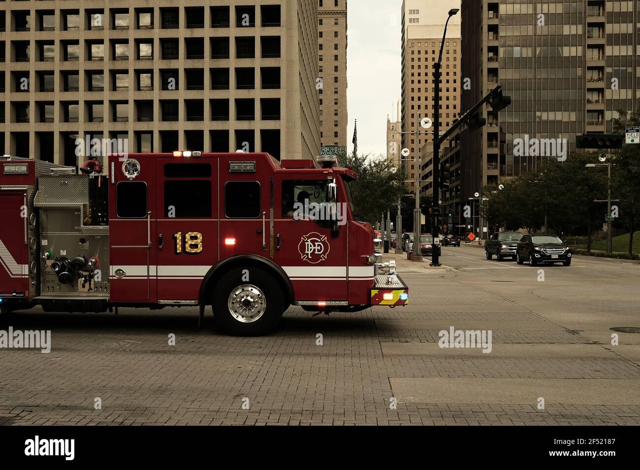 Dallas, TX, USA - 09 05 2020: Fire Truck driving into an intersection in downtown Dallas Stock Photo