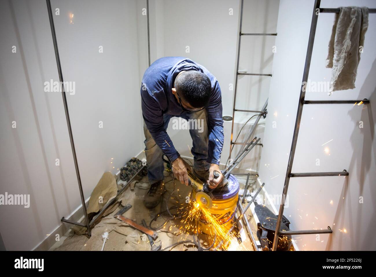 Colombian metal carpenter polishing metal in a dressing room Stock
