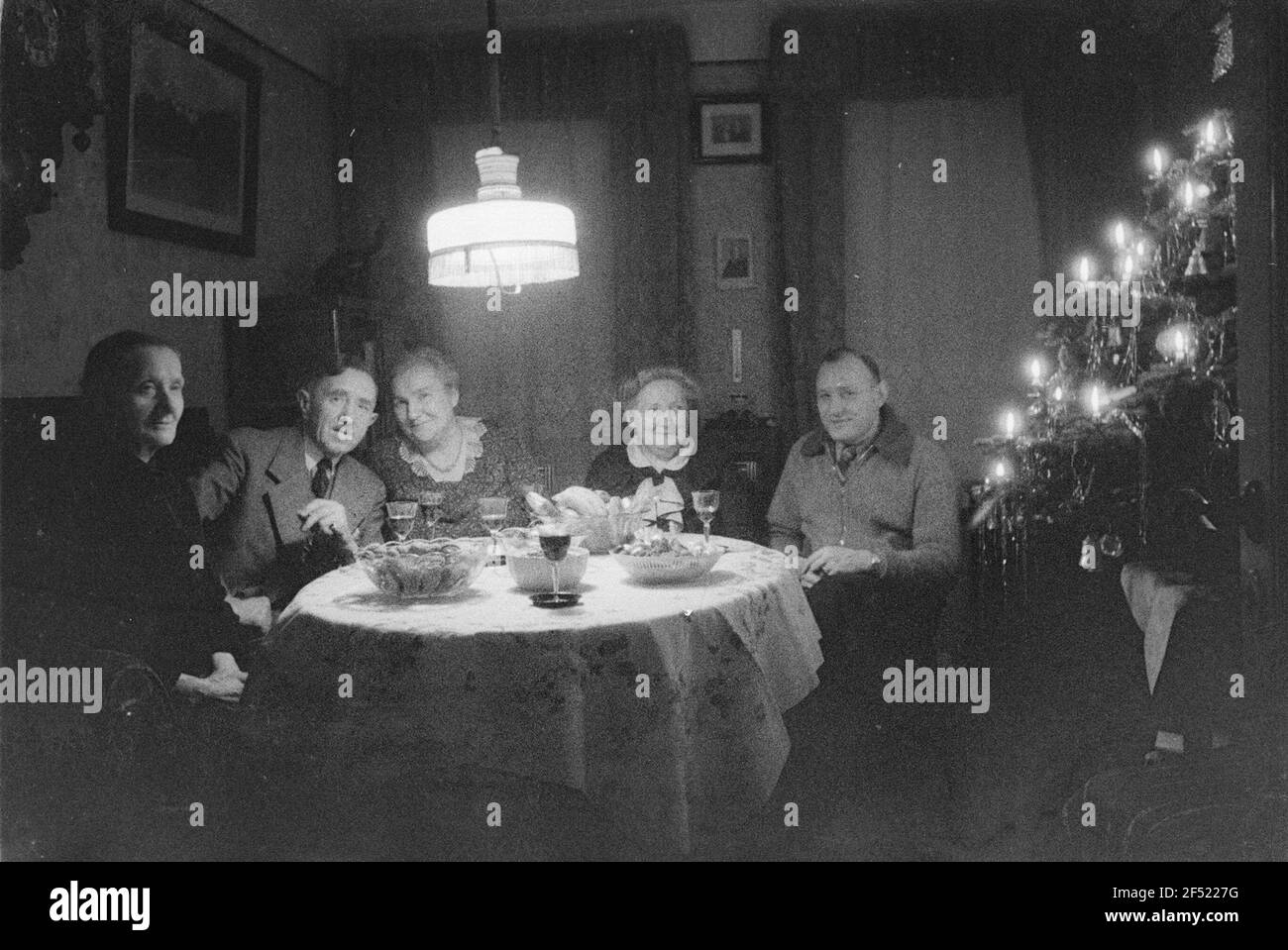 Private recordings. Family next to a Christmas tree Stock Photo