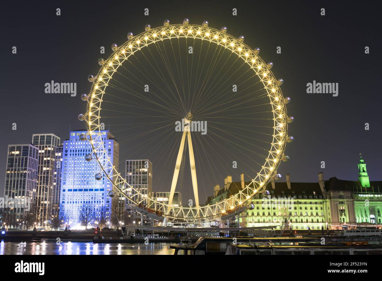 23rd March 2021, national reflection of first anniversary of covid-19 lockdown. remember for victims of coronavirus, London Eye light in yellow Stock Photo