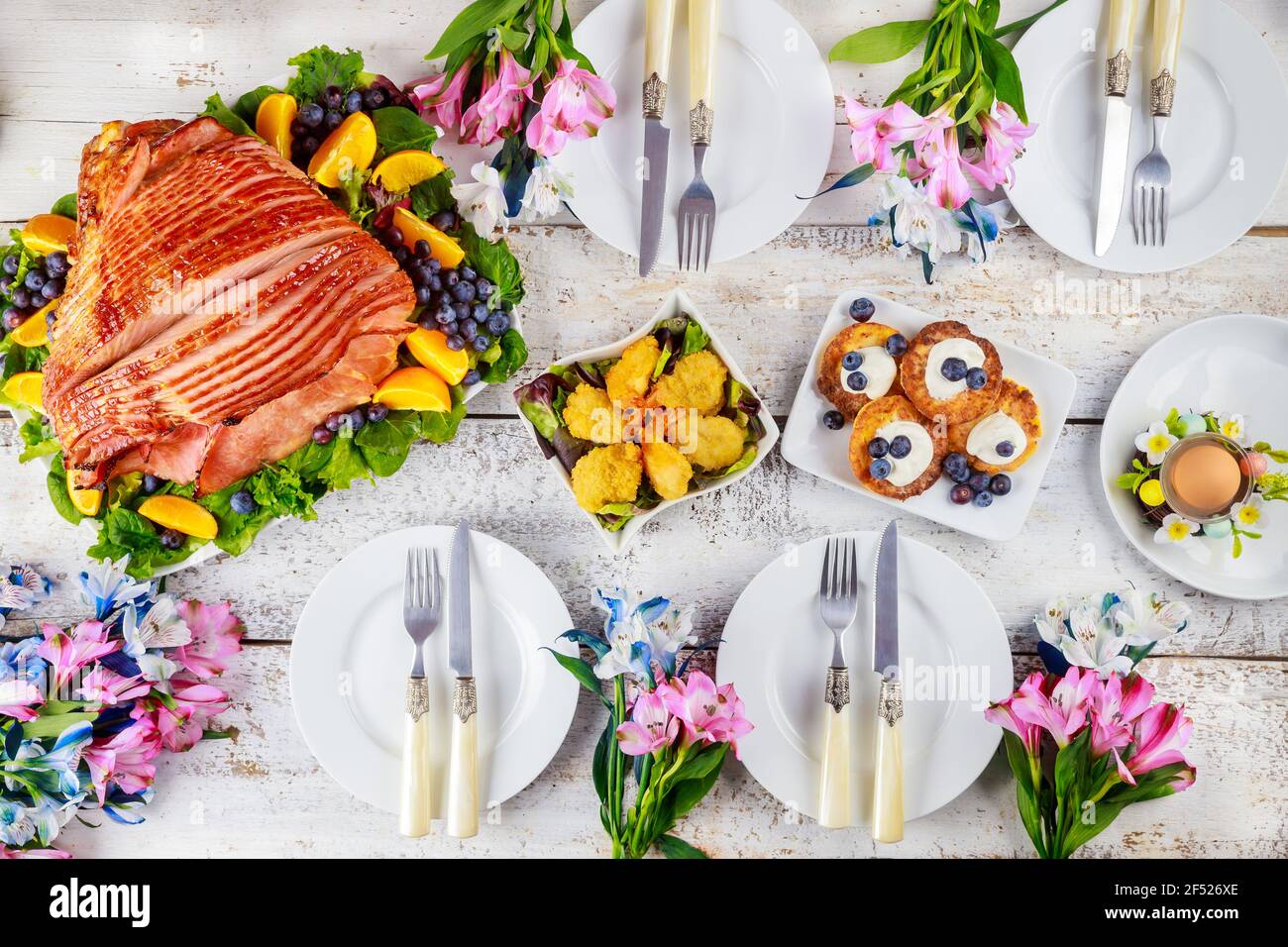 Table setting with baked pork ham on Easter table. Holiday concept. Stock Photo