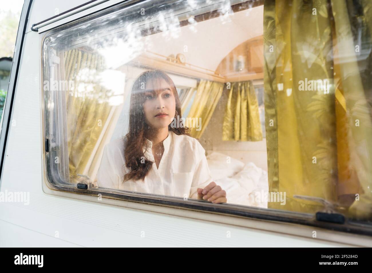 young woman looking view at window of a camper RV van motorhome Stock ...
