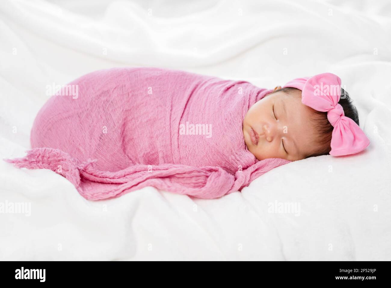 newborn baby sleep in pink cloth wrap blanket on a bed Stock Photo - Alamy