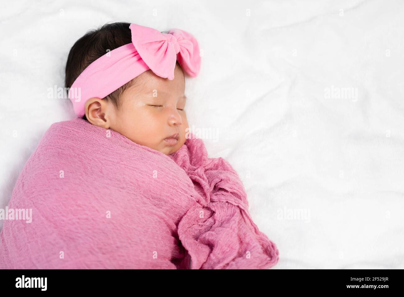 newborn baby sleep in pink cloth wrap blanket on a bed Stock Photo Alamy