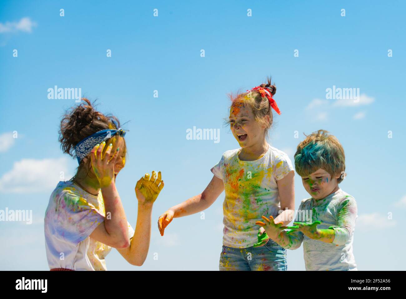 Portrait of a cute kids painted in the colors of Holi festival. Stock Photo