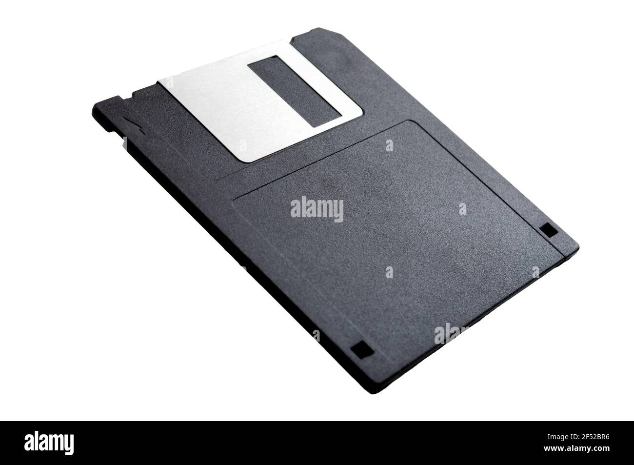 Obsolete data storage technology, retro digital medium and nostalgia concept with a tilted floppy disk isolated on white background leaning on its axi Stock Photo