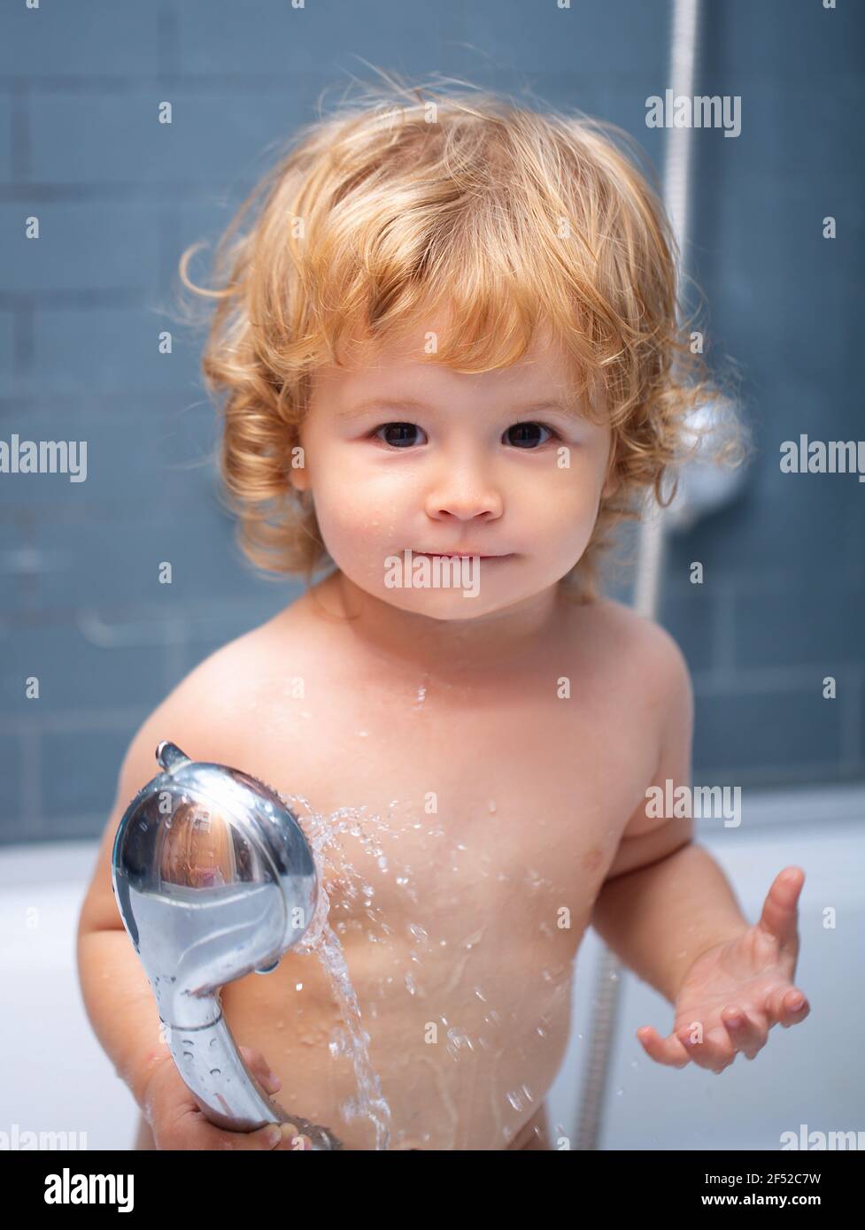 Kid shower. Cute baby boy enjoying bath and bathed in the bathroom