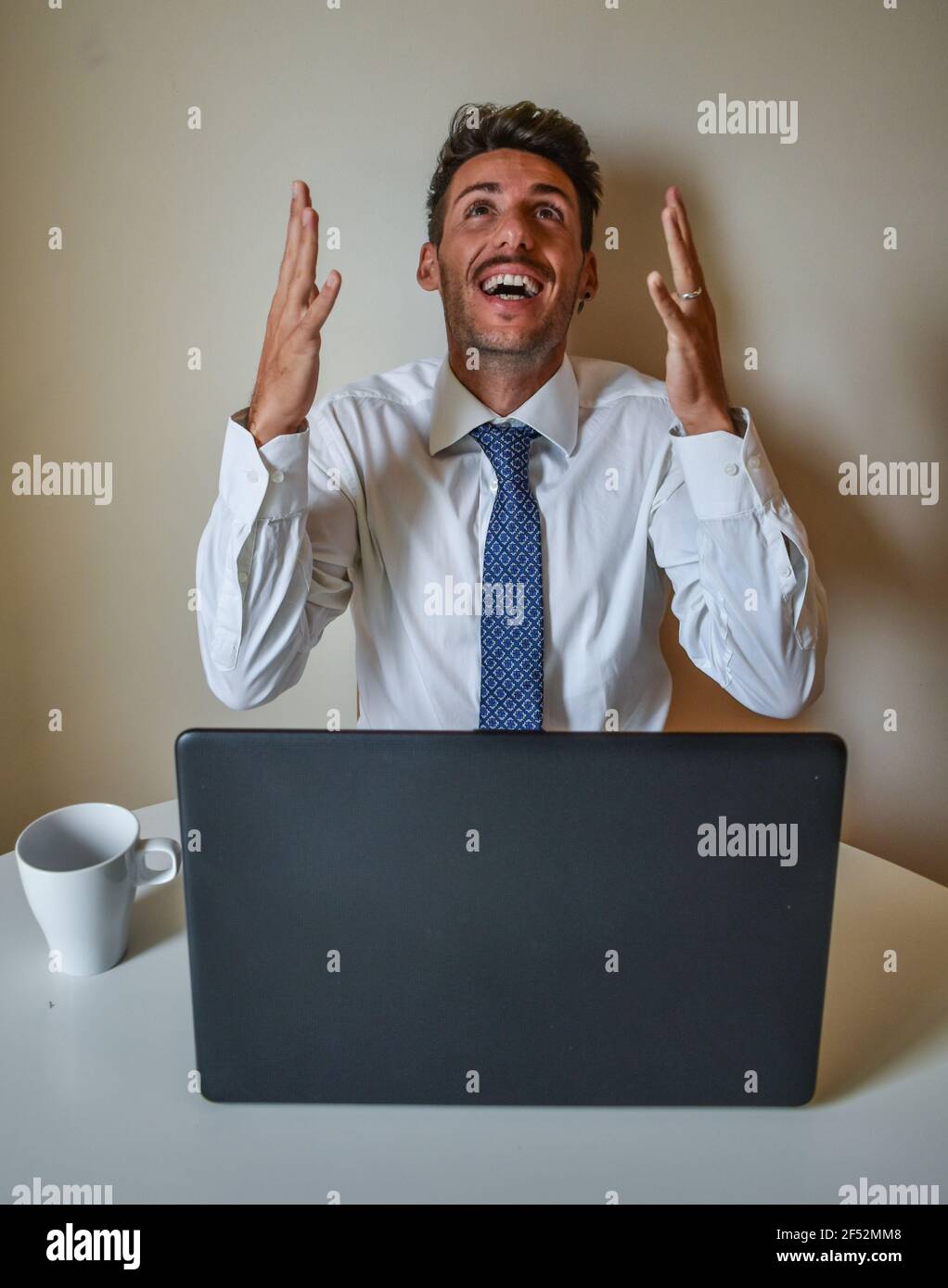 Happy Client Using Computer Happy Caucasian businessman celebrating a successful transaction with ...