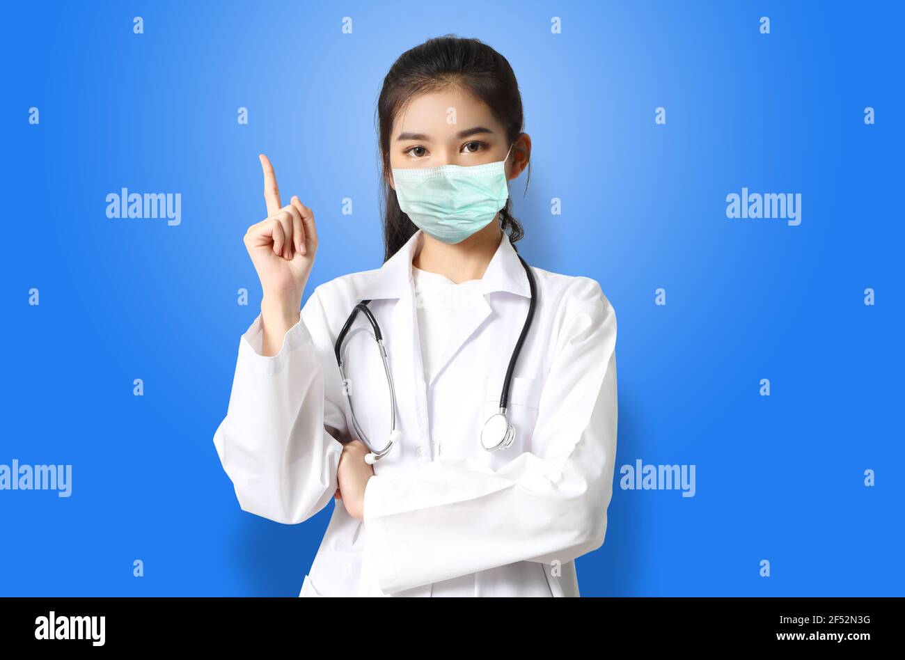 asian woman doctor in white uniform with mask Stock Photo