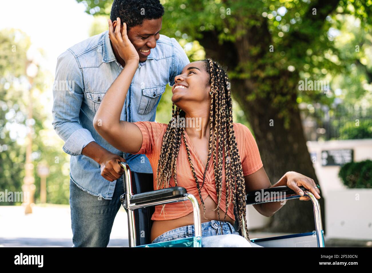 Woman in a wheelchair enjoying a walk with her boyfriend Stock Photo ...