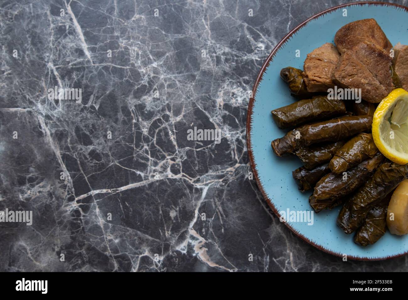 Top view, Plate with delicious, stuffed grape leaves called Dolma , made from vines with rice
