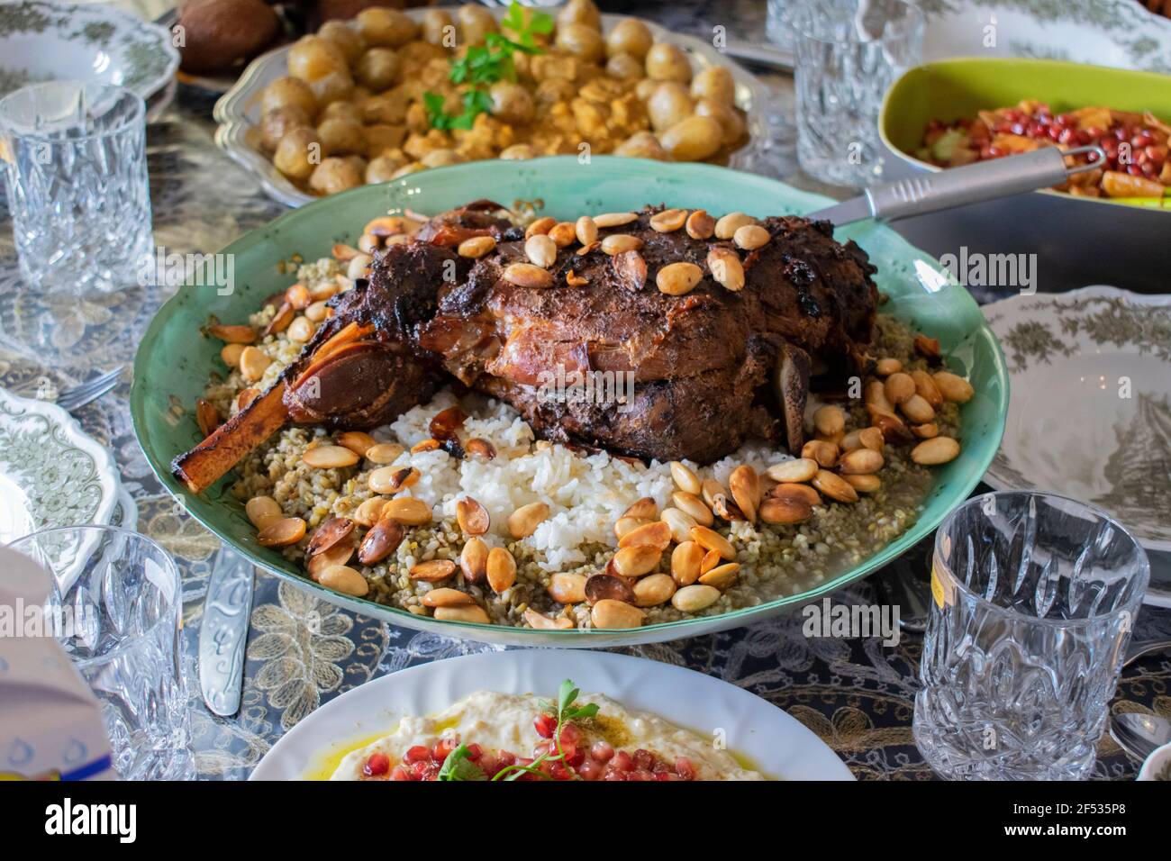 Grilled lamb thigh,on durum wheat or frikeh or rice and nuts top view on a  dinner table Stock Photo - Alamy