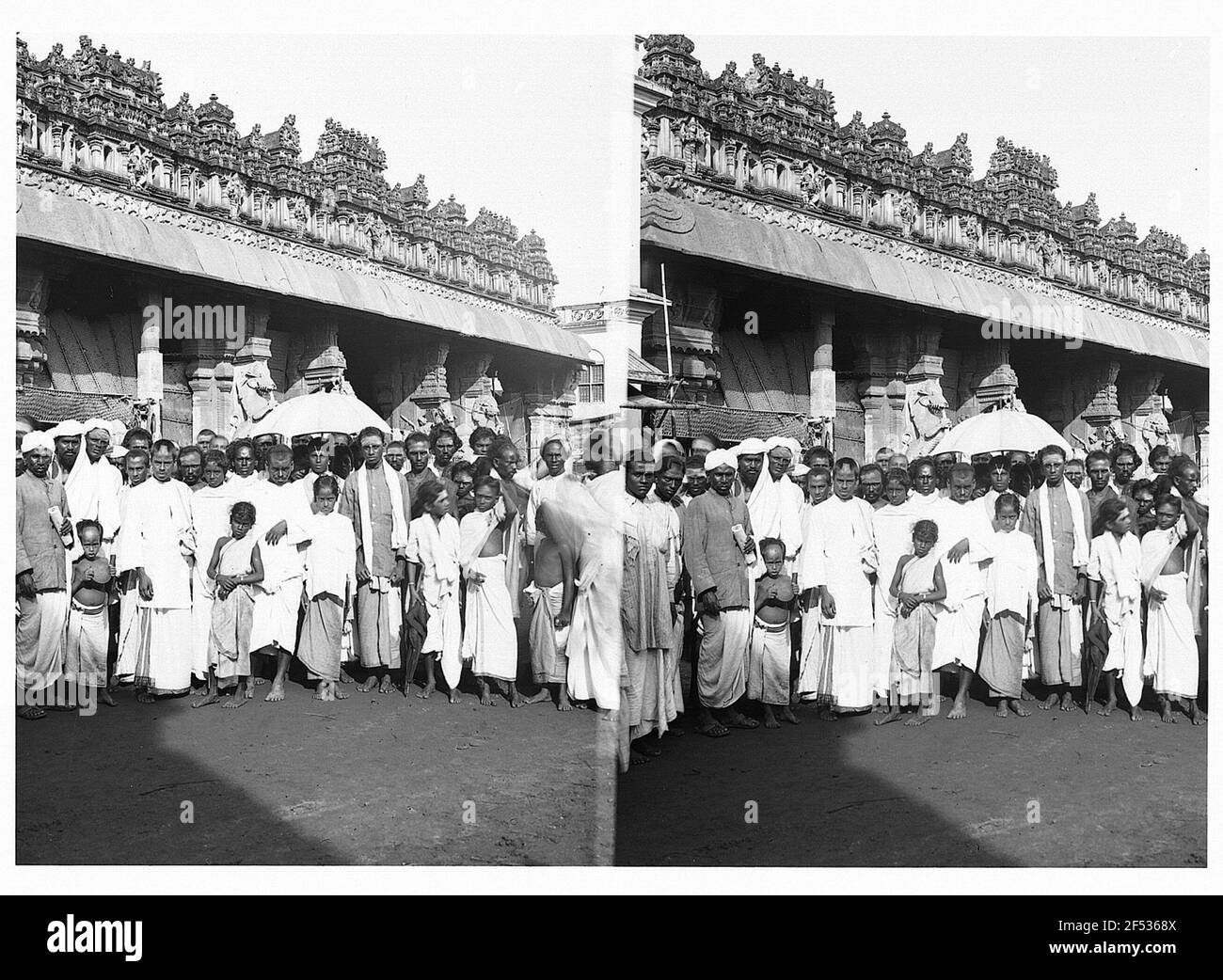 India. Group of Indian men and children posing in front of a temple Stock Photo