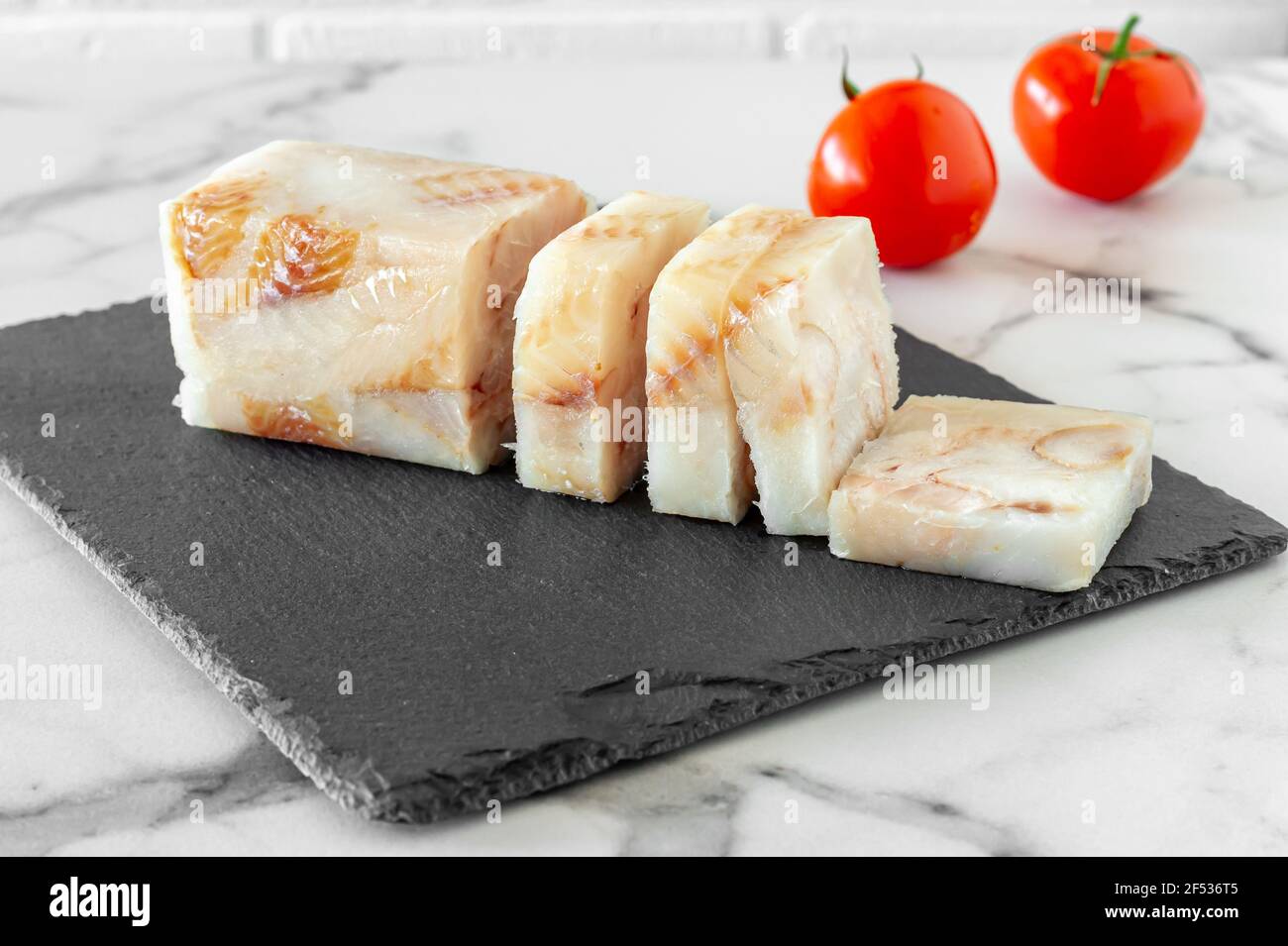Frozen Fillet of Fish Pangasius on stone board ready for cooking Stock Photo