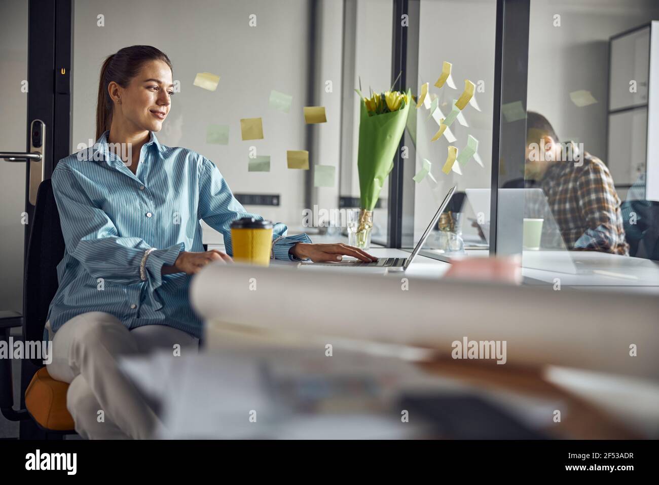 Smiling cute young woman focused on her work Stock Photo