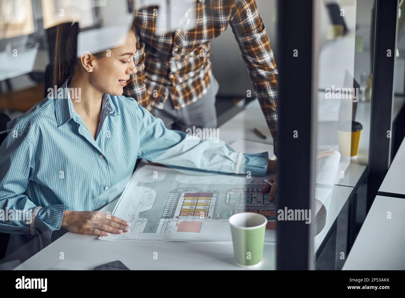 Two designers working at a new building plan Stock Photo