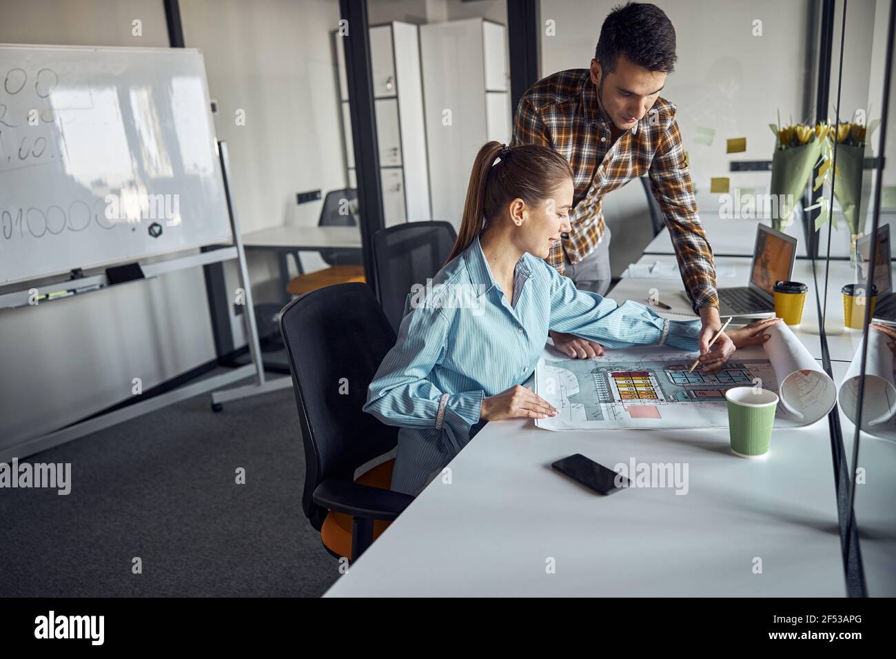 Engineer and his coworker creating a technical drawing Stock Photo