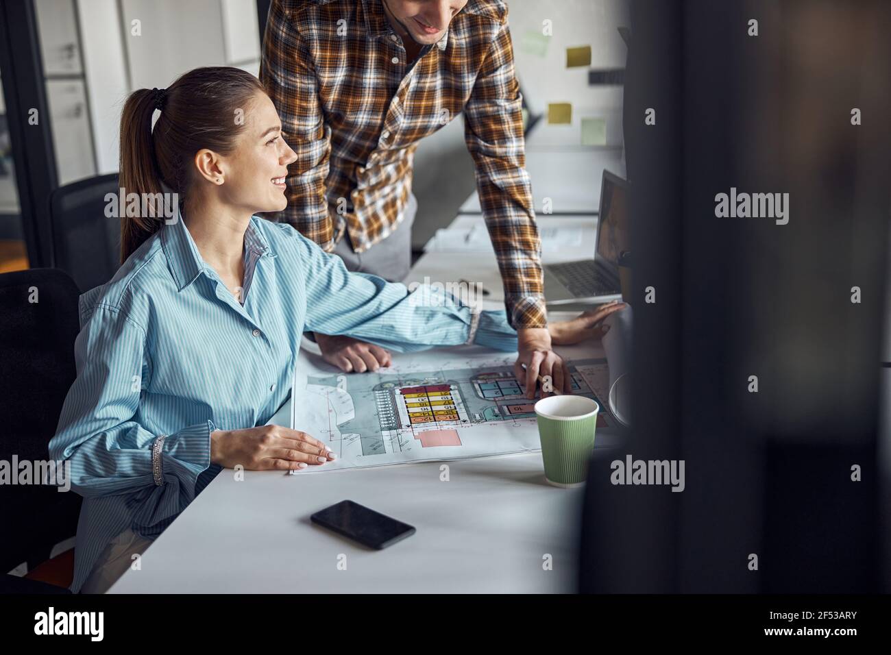 Two designers working at a new technical drawing Stock Photo