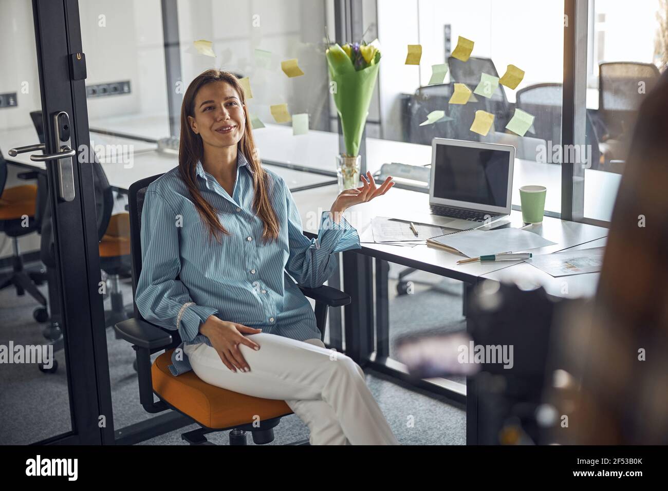 Joyous employee posing for the camera in the workplace Stock Photo
