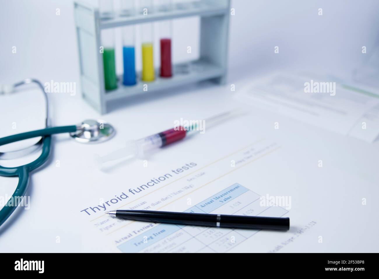 Thyroid function Labor analysis result or medical test result ,A sheet or paper  with Thyroid function and colored test tubes in the background Stock Photo
