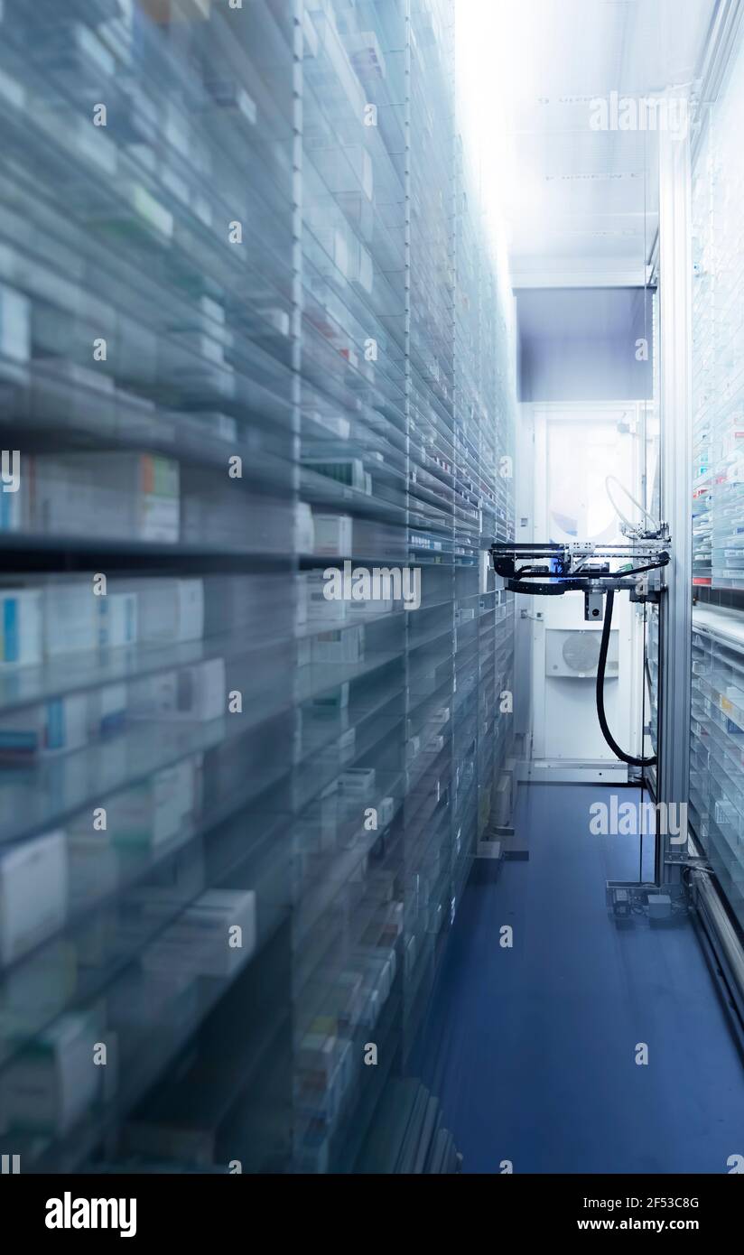 Modern pharmacy storage room and  robot hand s are arranging and storing out drugs in a pharmacy Stock Photo