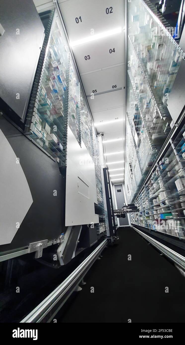 Modern pharmacy storage room and  robot hand s are arranging and storing out drugs in a pharmacy Stock Photo