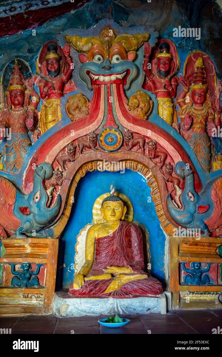 Ancient colorful statue of the Buddha in Ravana Temple near Ella town