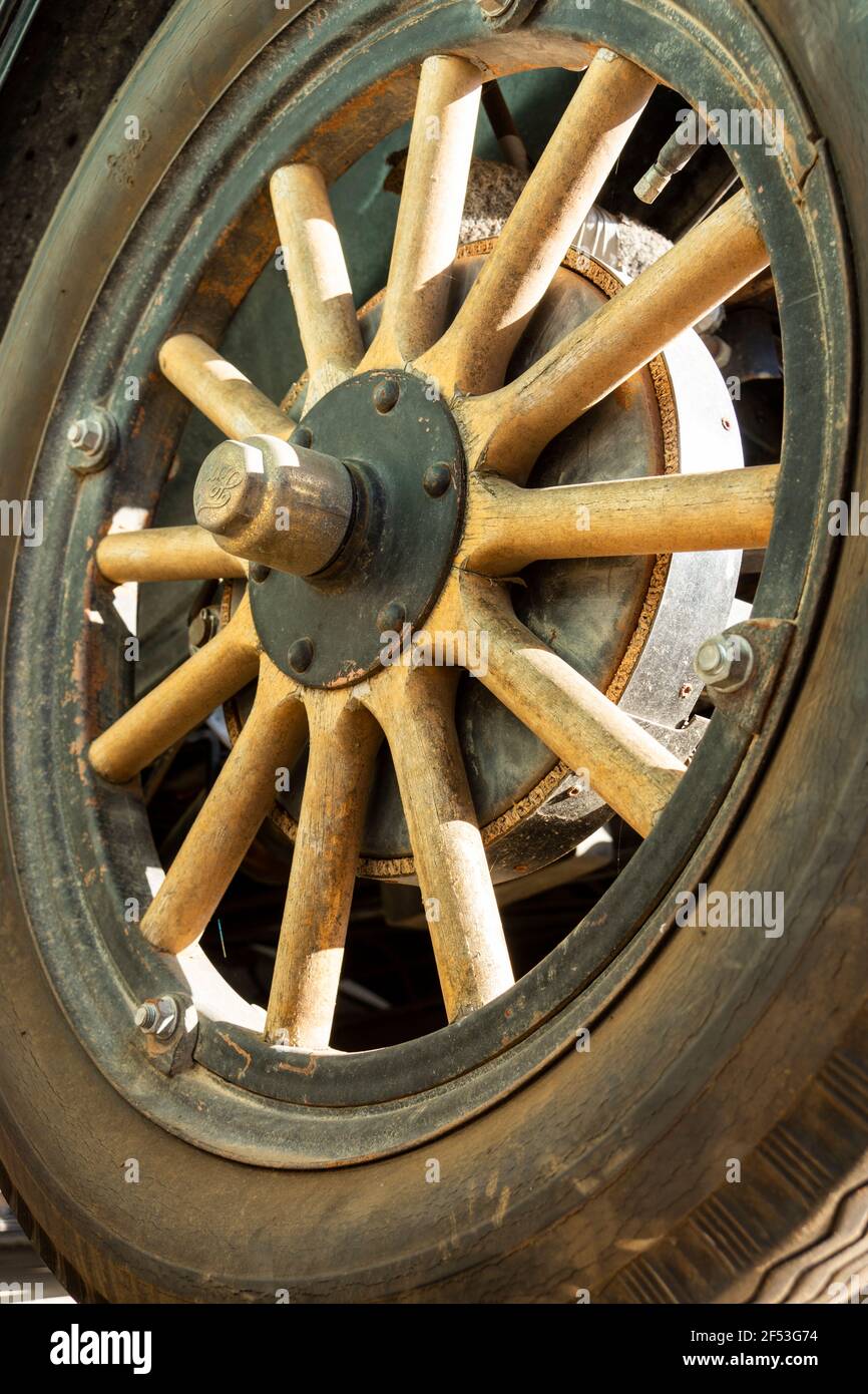 An old wooden spoked wheel from a vintage car. Stock Photo