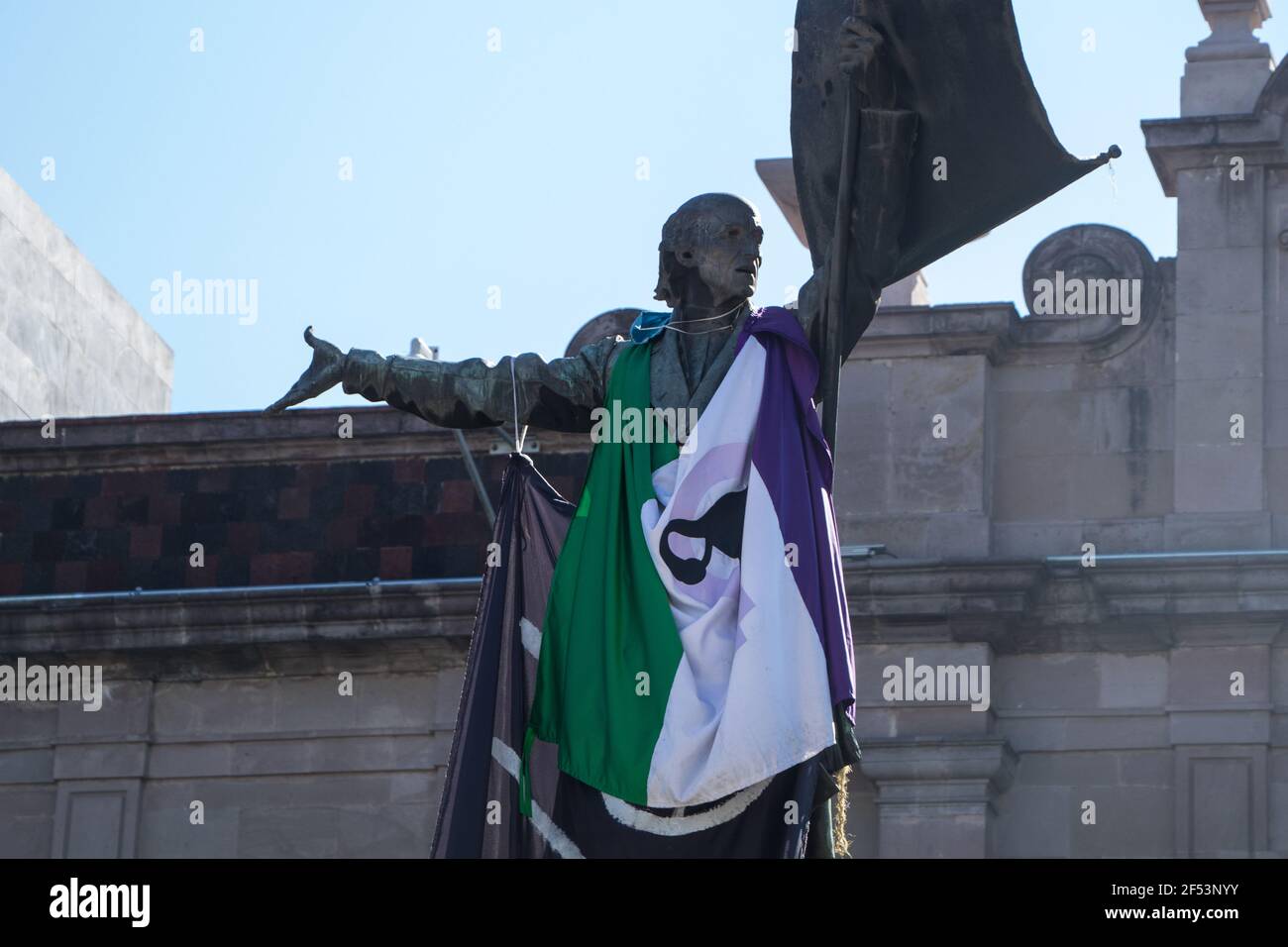 Non Exclusive: TOLUCA, MEXICO - MARCH 23: Miguel Hidalgo statue with a feminist flag  during a protest of women to demand decriminalization of abortio Stock Photo