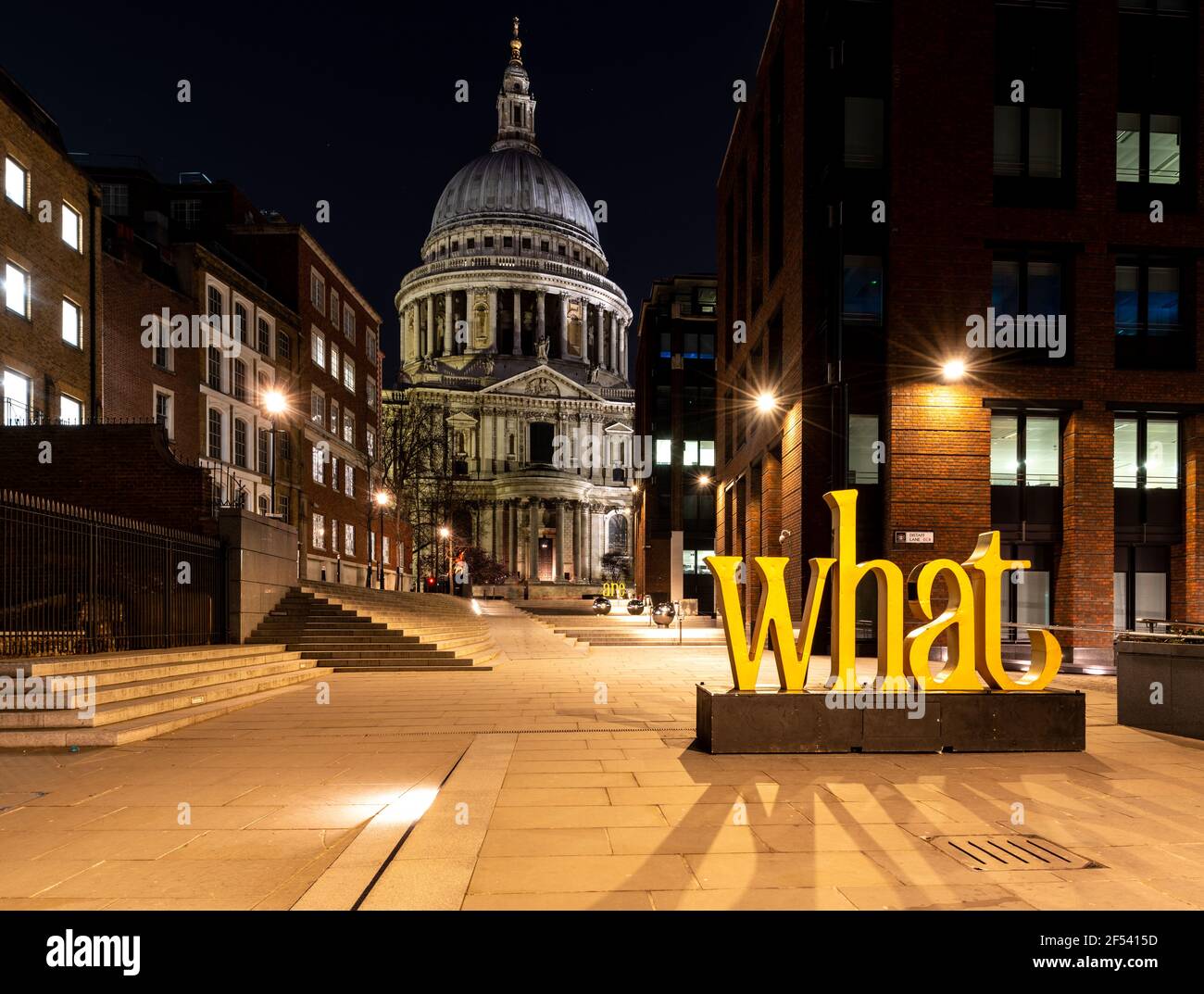 St Paul's cathedral at night with the word What lit up in yellow Stock Photo
