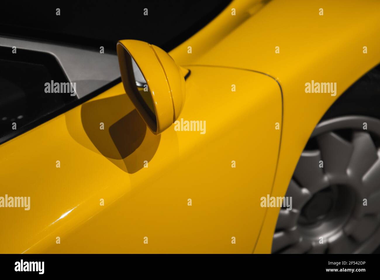 Yellow sports car mirror, close up photo, abstract modern car design