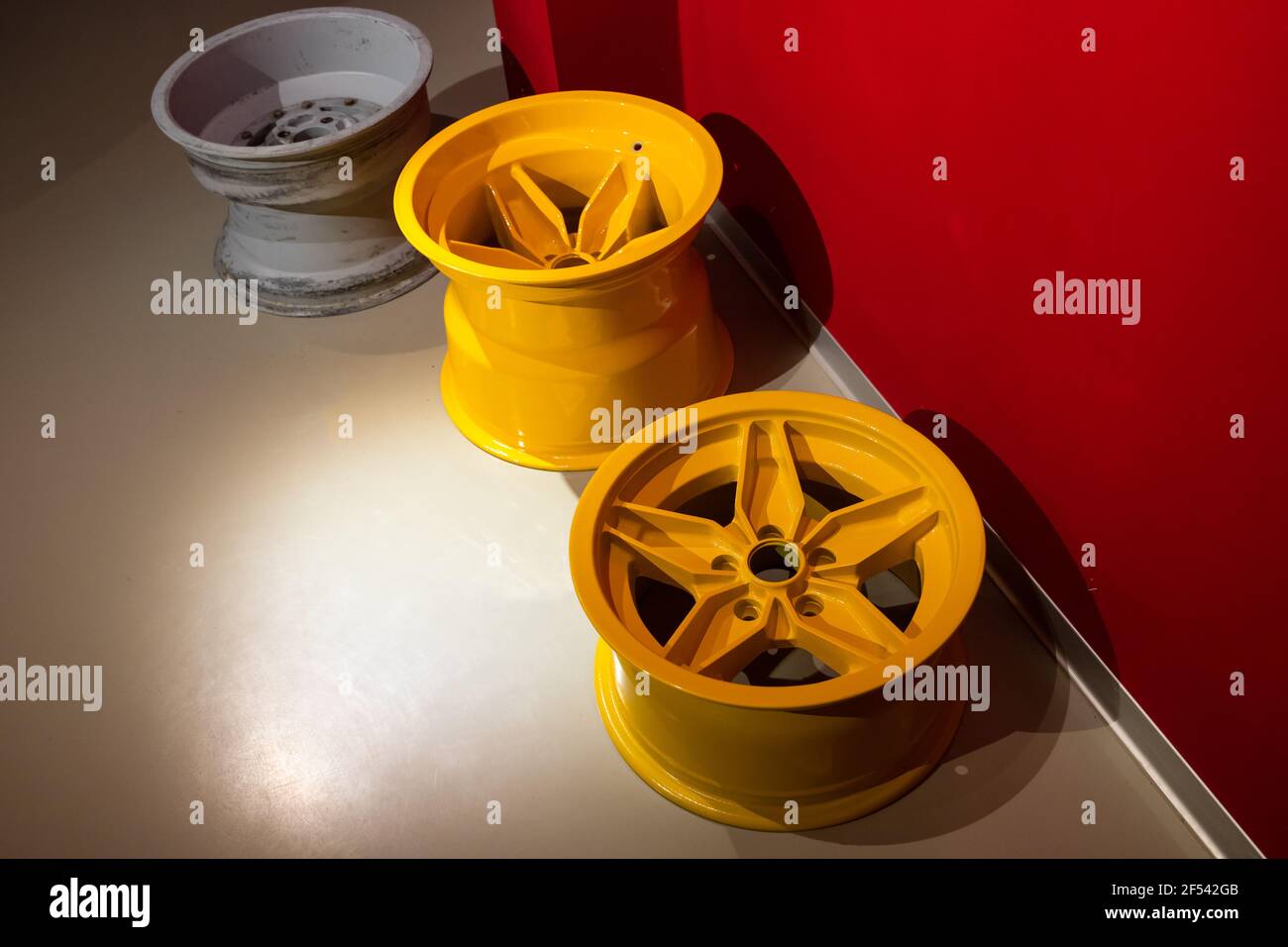 Forged sports car rims lay on a garage floor. Abstract modern sports car design template Stock Photo