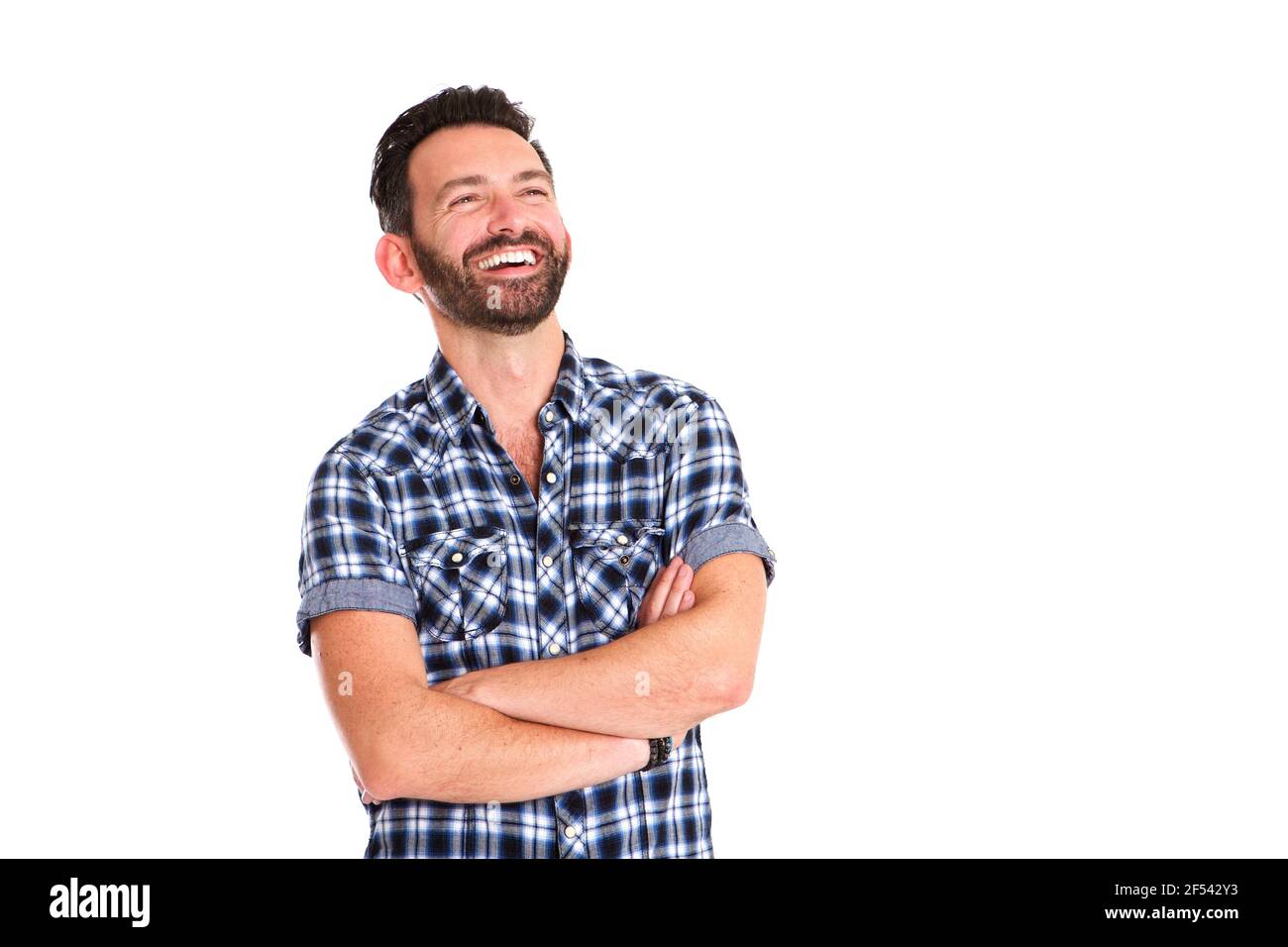 Portrait of handsome mature man standing with arms crossed and smiling ...