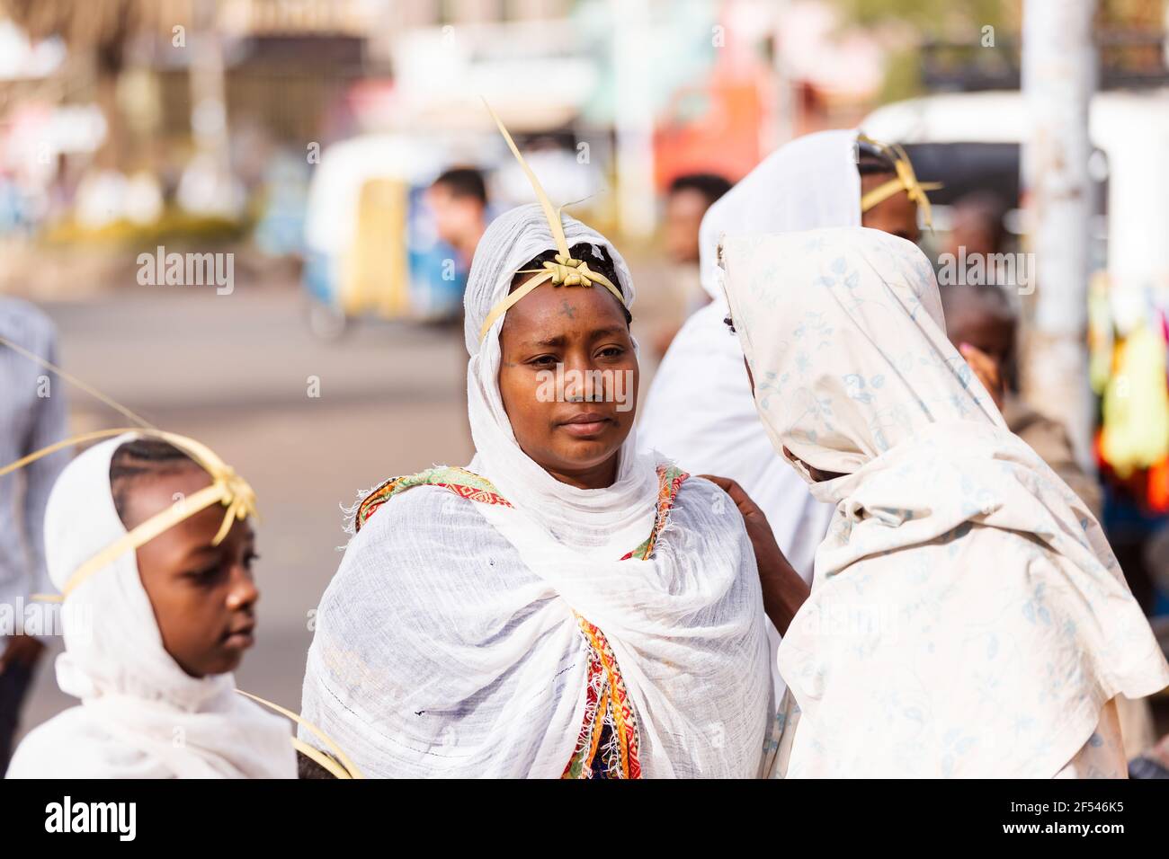 Azezo, Amhara Region, Ethiopia - April 21, 2019: Orthodox Christian woman white dressed walk to mass on the street during easter holiday. Bahir Dar, E Stock Photo