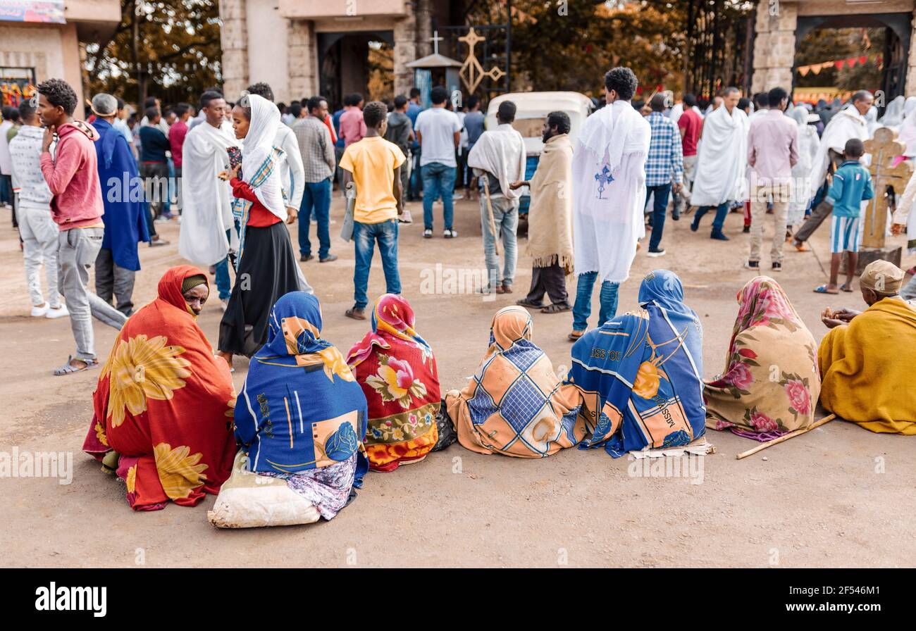Azezo, Amhara Region, Ethiopia - April 21, 2019: Orthodox Christian people behind church waiting for mass on the street during easter holiday. Bahir D Stock Photo