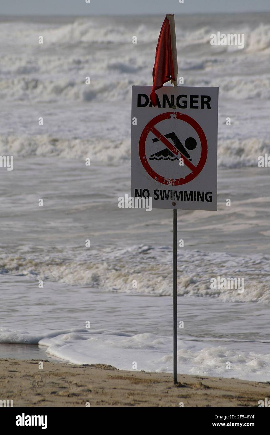No Swimming sign. Gold Coast surf lifesavers' red flag for dangerous conditions on beach