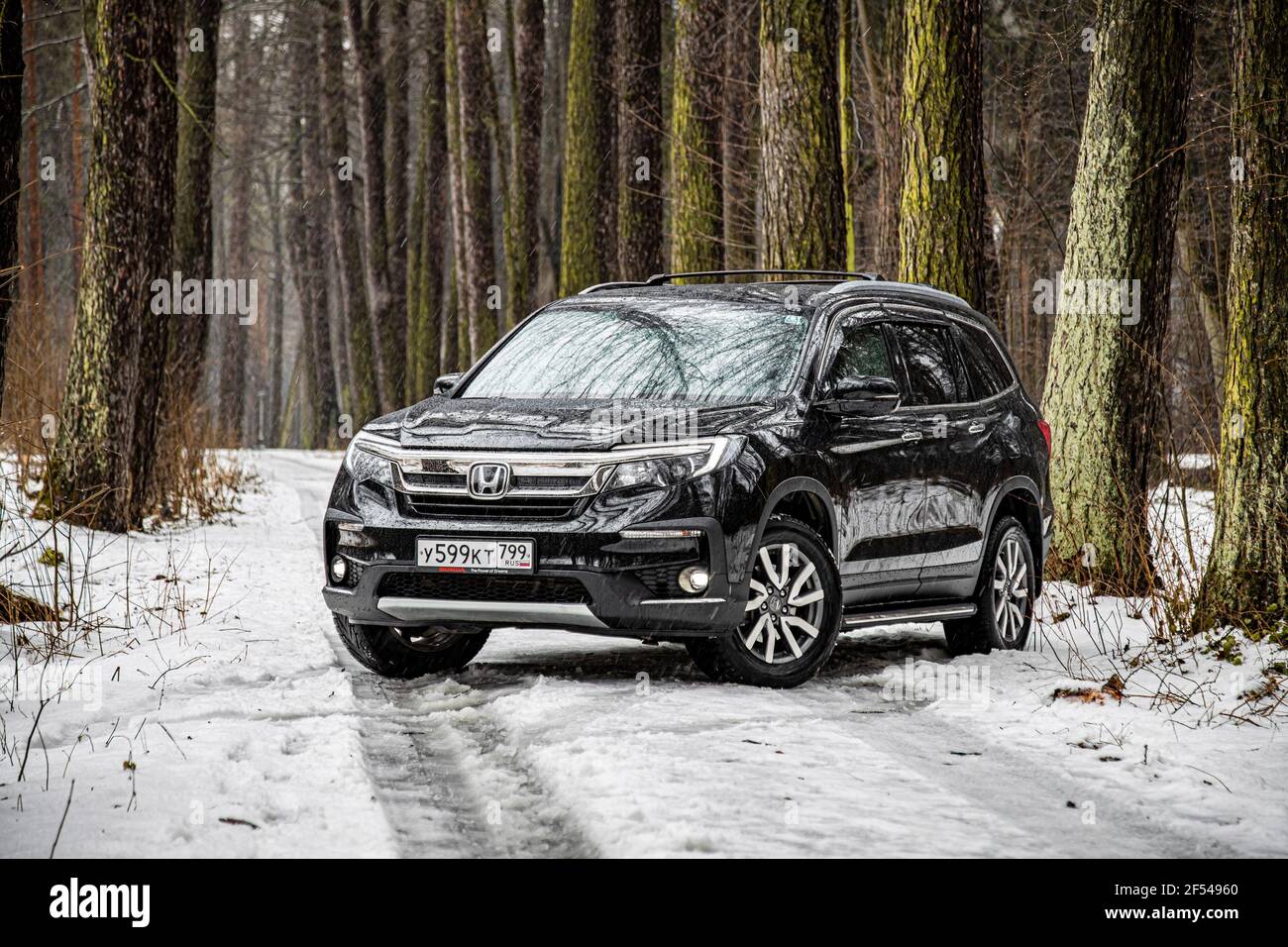 Moscow, Russia - February 2, 2020: Exterior of the new premium SUV Honda Pilot in winter forest landscape Stock Photo