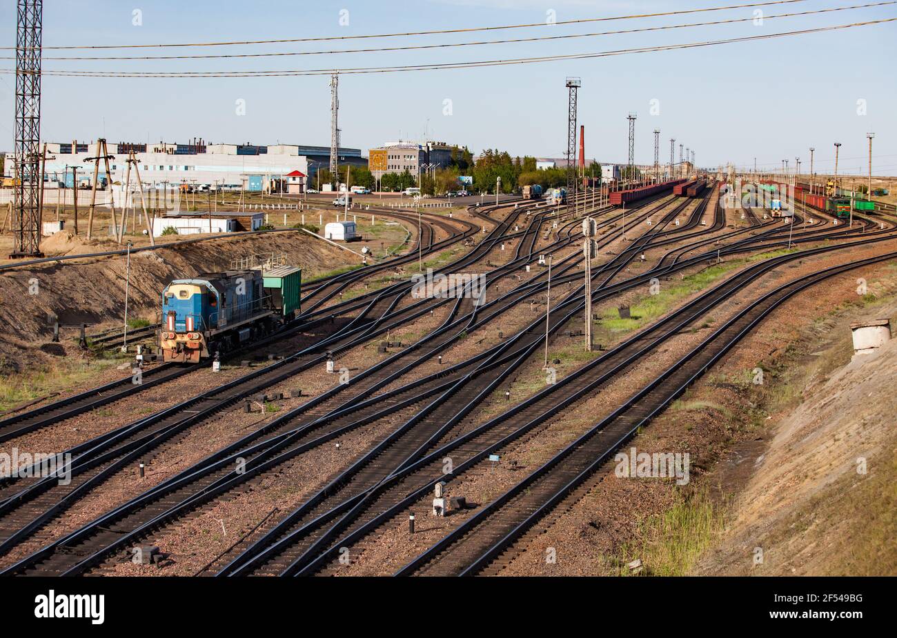 Rails and trains panorama. Railway station 'Bogatyr' near coal quarry. Kazakhstan, Ekibastuz. Stock Photo