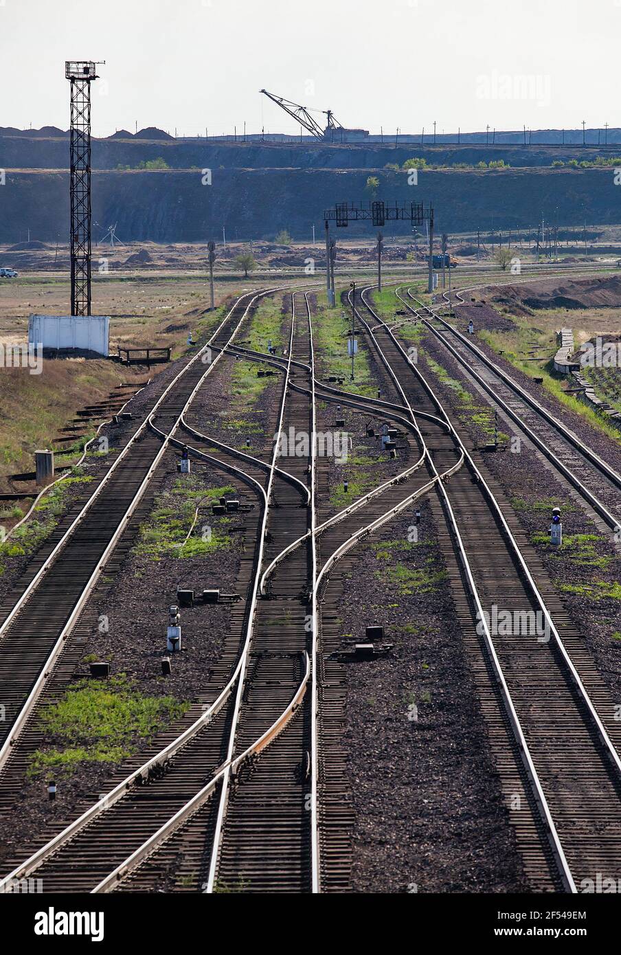 Railway station 'Bogatyr' near coal quarry. Rail tracks and dragline excavator on background. Ekibastuz, Kazakhstan. Stock Photo