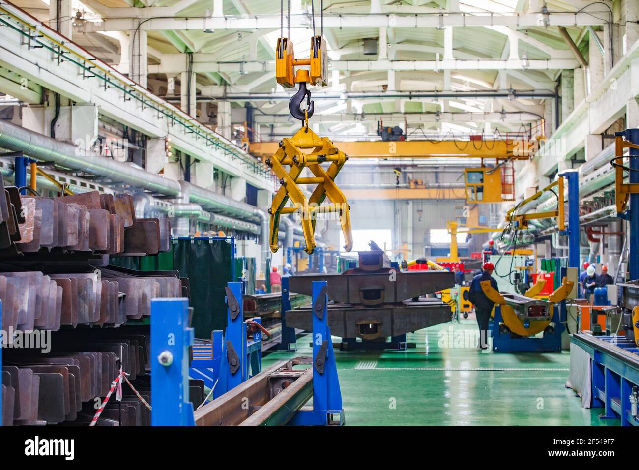 Ekibastuz, Pavlodar region, Kazakhstan May 28 2012: Car-building plant workshop. Overhead crane with mechanical hand. Stock Photo