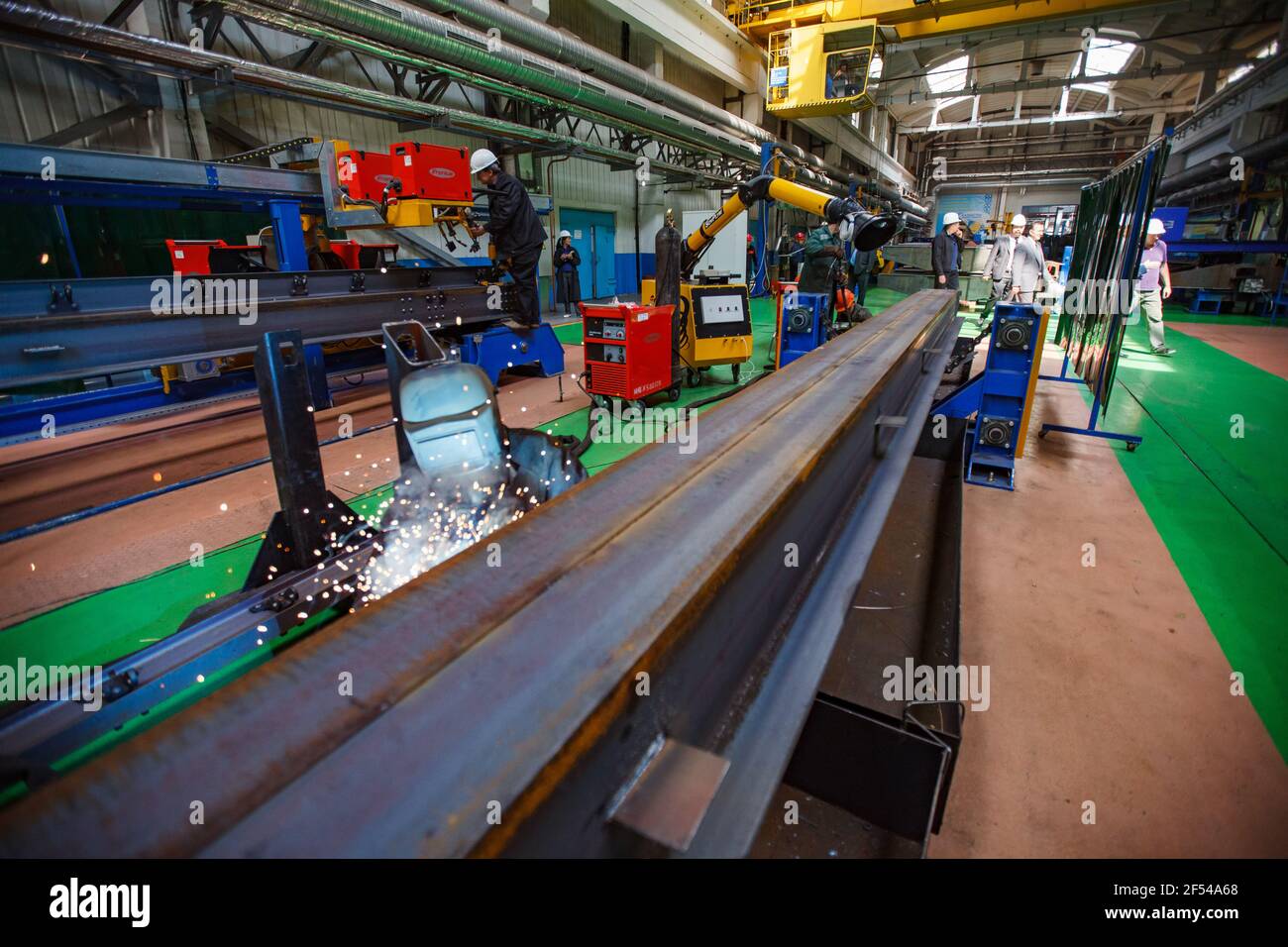 Ekibastuz, Pavlodar region, Kazakhstan: Car-building plant. Welding steel rail part. Smoke suction machine (fume extractor) in focus. Stock Photo