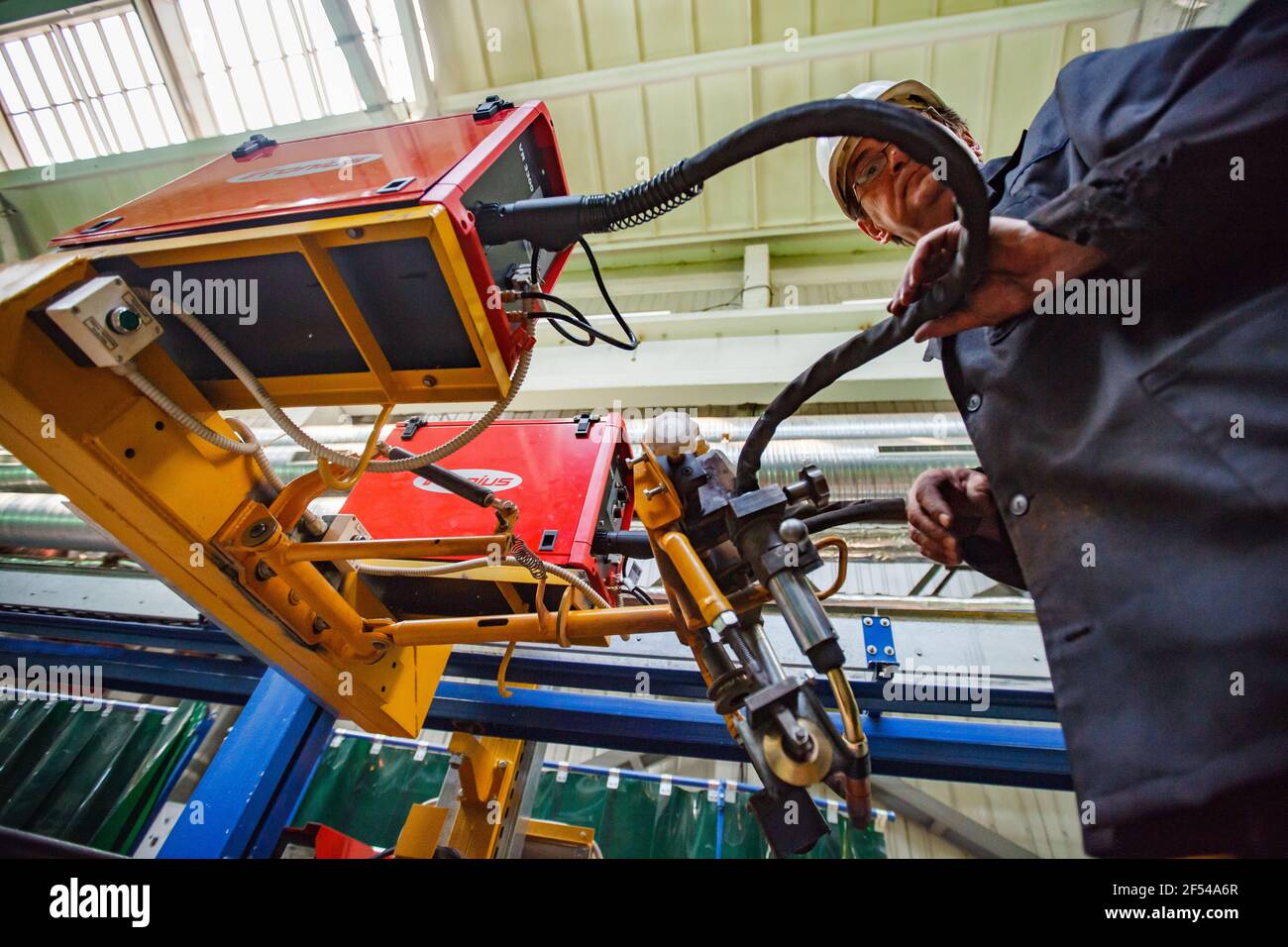 Ekibastuz, Pavlodar region, Kazakhstan May 28 2012: Carriage-building plant. Welder worker with automatic welding machine. Stock Photo